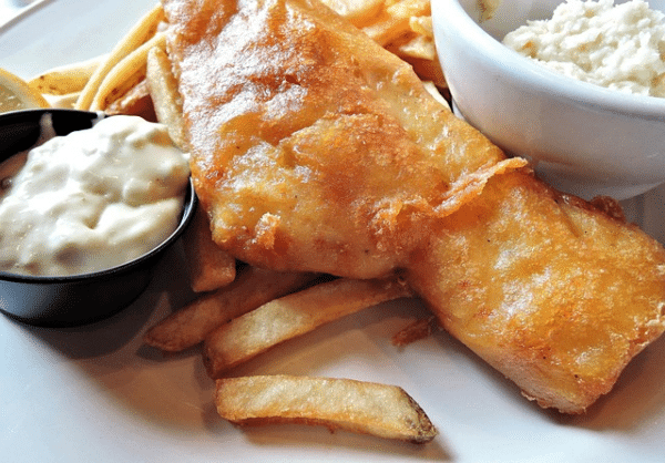 Fresh fried with with a creamy seafood sauce sits lays atop a bed of chips.